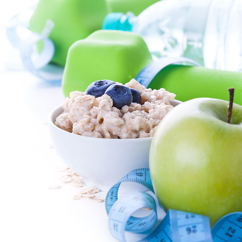 Weight Loss - in the photo is an apple, oatmeal and tape measure